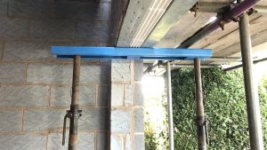 Prop Pal 1200 Needle System in use on a construction site. In this photo the Prop Pal system is being used to hold up part of a partially constructed wall.