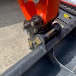 A photo of an excavator's arm at the point where it joins the bucket. The join features the new quick hitch system.