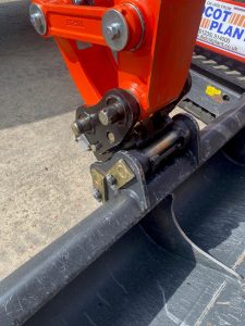 A photo of an excavator's arm at the point where it joins the bucket. The join features the new quick hitch system.