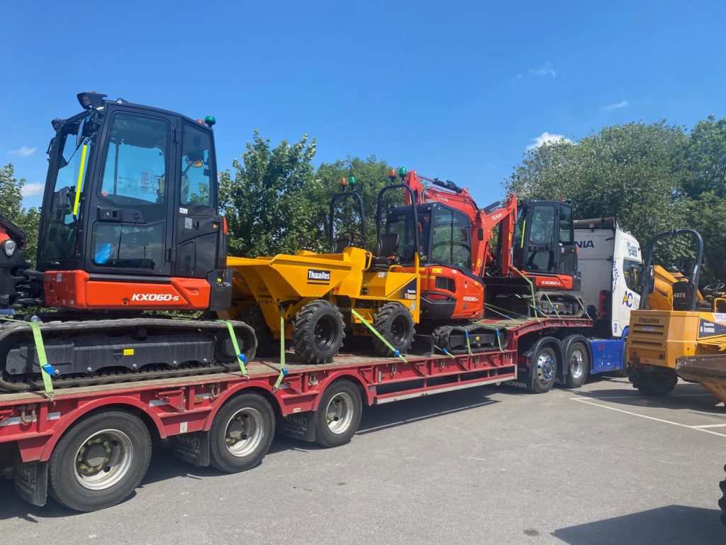 In this photo a lorry with a long trailer is delivering new plant to Didcot Plant. Strapped on to the trailer is three new mini excavators and a new dumper.